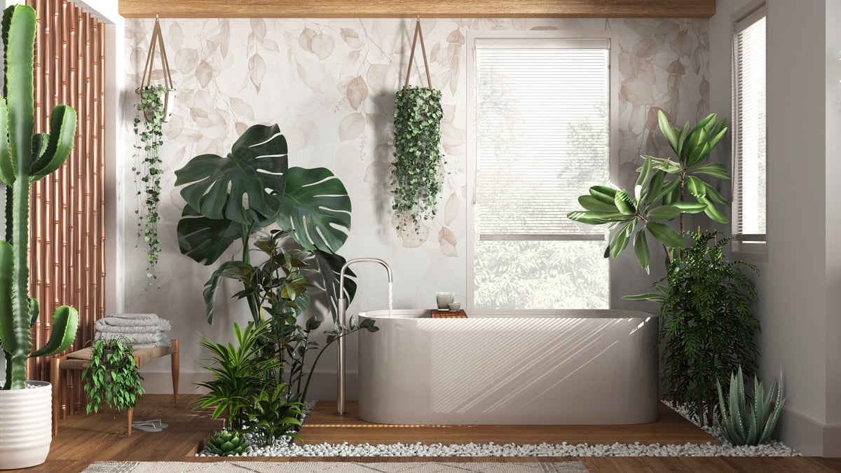 Modern wooden bathroom in white and beige tones with freestanding bathtub. Biophilic concept, many houseplants. Urban jungle interior design